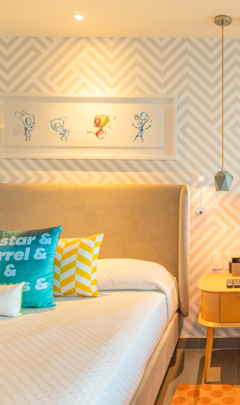 A Bedroom With A Bed And Desk In A Room